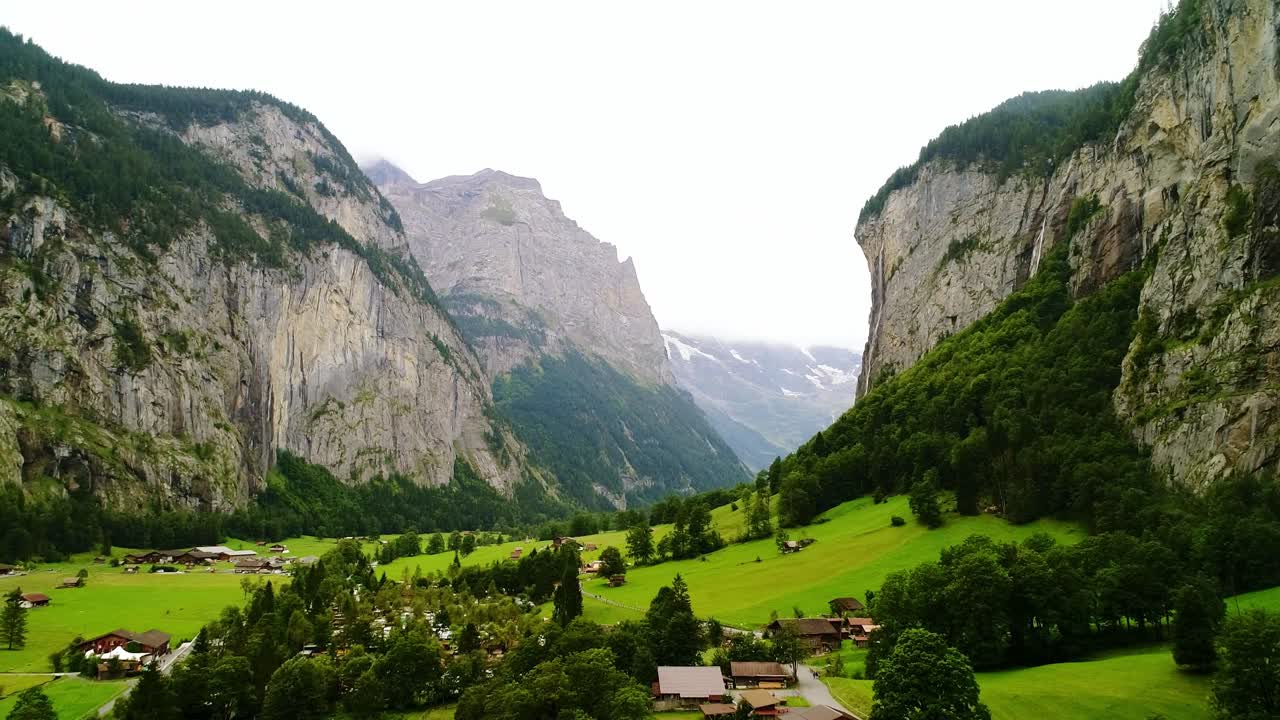 Drone of Lauterbrunnen Valley, cliffs and alpine meadows, smoothly panning left