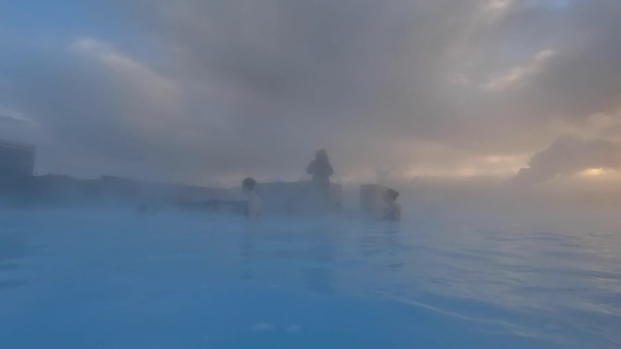 Sunrise inside blue lagoon in iceland during winter thermal bath