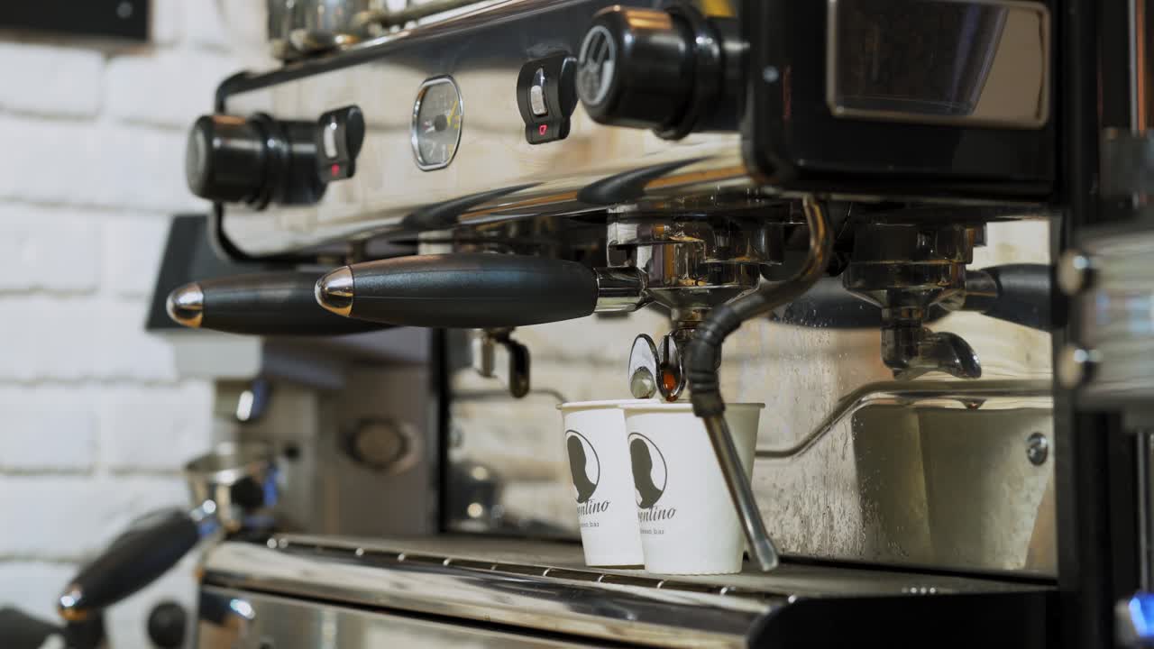 Flowing fresh ground coffee. Pouring coffee stream from professional machine in cup