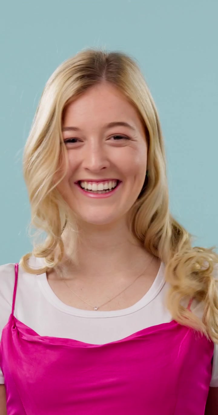 Happy Young Woman Playing With Her Blonde Hair