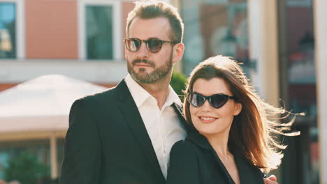 couple in stylish suits outdoors