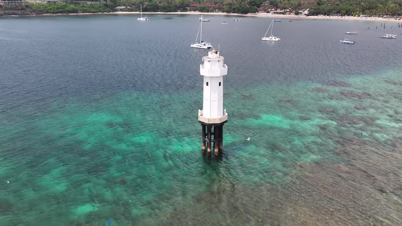 Beautiful tropical coastal Senggigi Beach and white lighthouse. Indonesia, travel, drone.