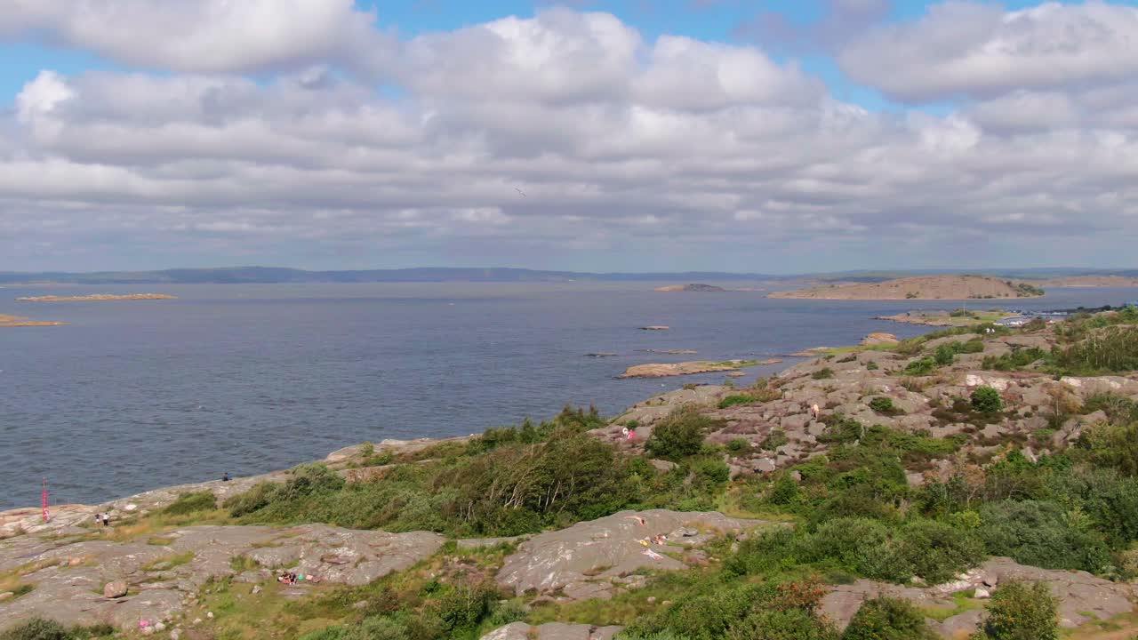 Sun-drenched coastal rocks overlooking the vast, open sea