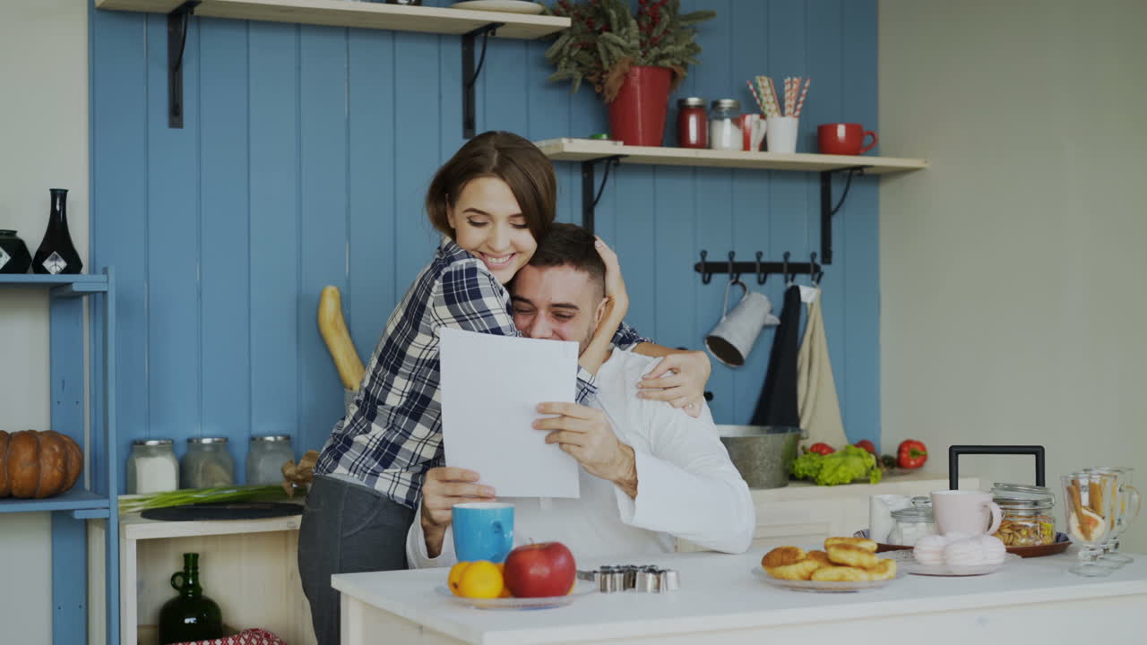 Couple Celebrating Good News in the Kitchen