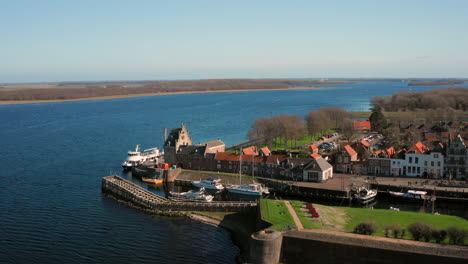 Aerial:-The-historical-town-of-Veere-with-an-old-harbour-and-churches,-on-a-spring-day