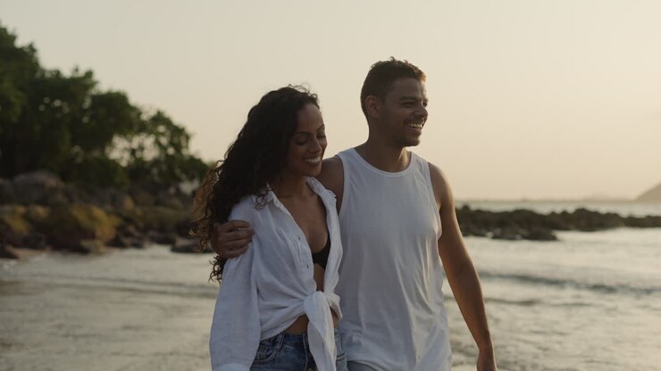 Un couple se promène sur la plage.