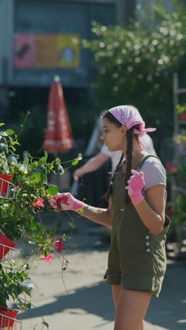 girl looking at plants in a market