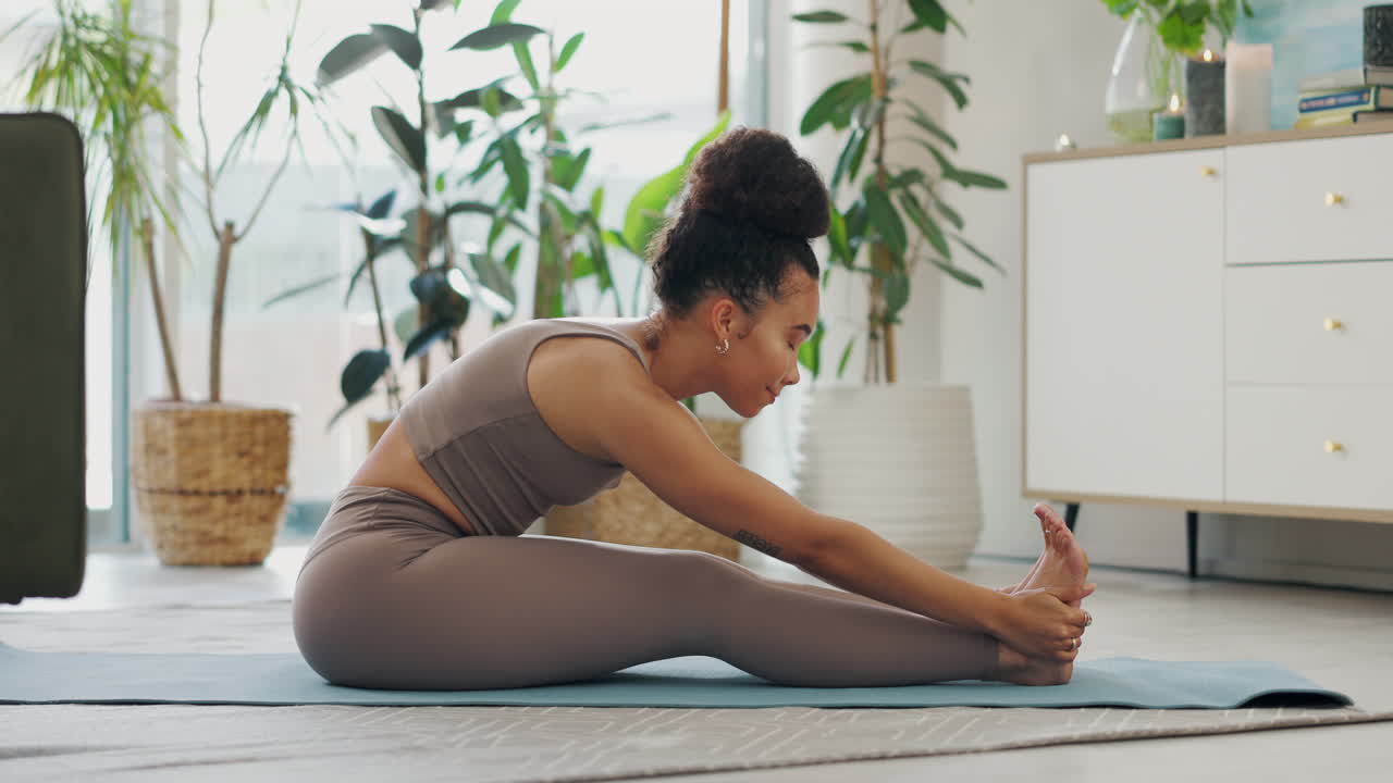 Woman Doing a Seated Leg Stretch at Home