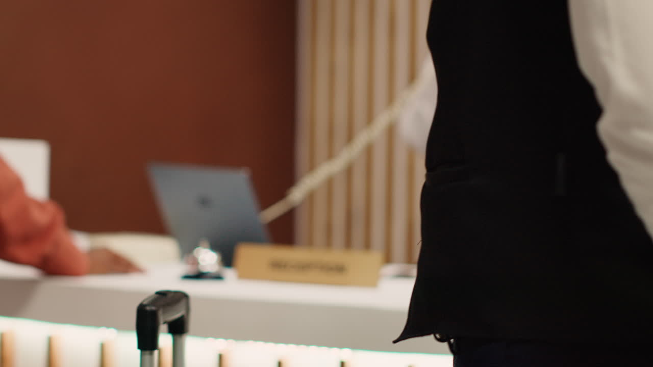 Thankful hotel guest tipping bellboy