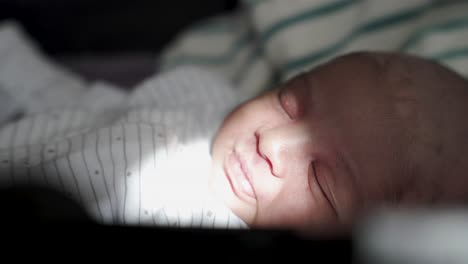 sleeping newborn baby with natural sunlight hitting face