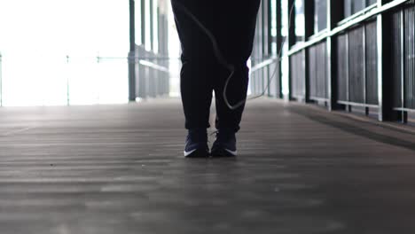 person jumping rope indoors