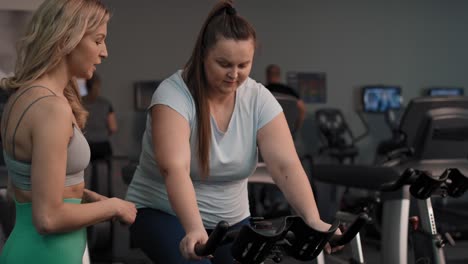 female caucasian trainer cooperate with overweight woman.