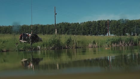 fisherman pulls out the fishing rod with the fish caught