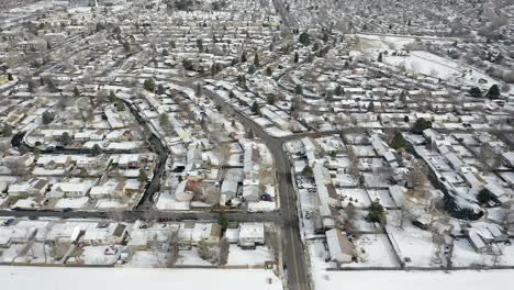 drone pans over snow covered neighborhood