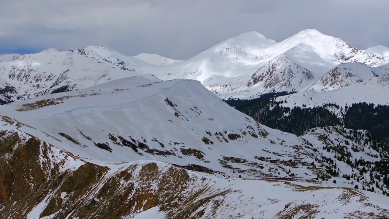 Snow covered Grays and Torreys Peak aerial drone Colorado Montezuma Deer Creek deep backcountry powder winter spring sunny clouds Rocky Mountain White River National Forest forward pan up motion