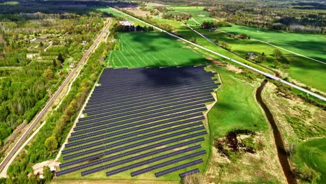 flying above field edges and solar installation with dramatic cloud cover and orbit