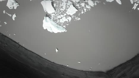 aerial top down dramatic icebergs floating in water, jokulsarlon lake, natural climate snow landscape, iceland