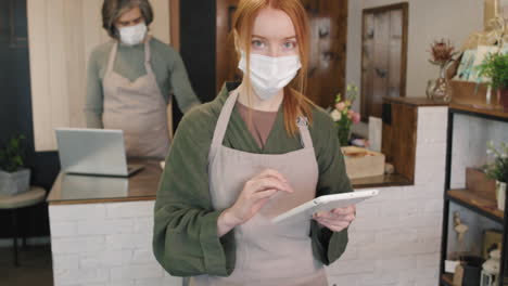 portrait of pretty florist in mask