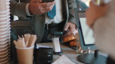 close up customer making contactless payment using smartphone mobile money transfer spending money in cafe with digital transaction service technology