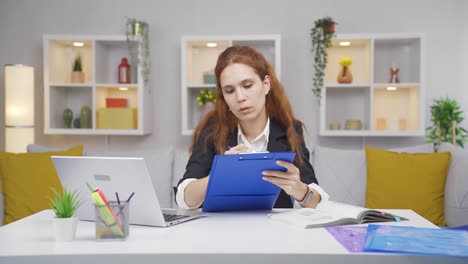 Home-office-worker-woman-taking-notes,-jotting-down-information.