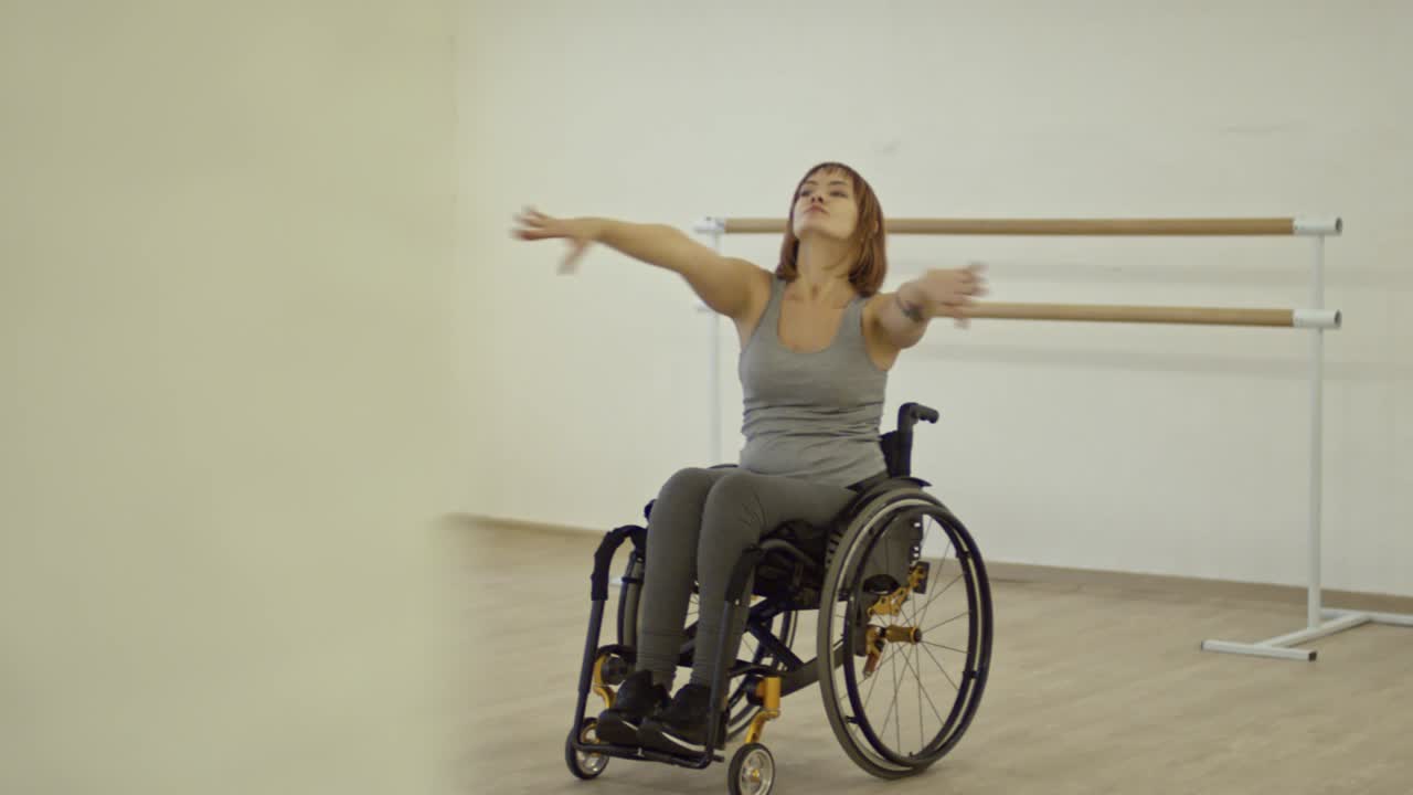 Paraplegic Woman in Wheelchair Learning Dancing Moves