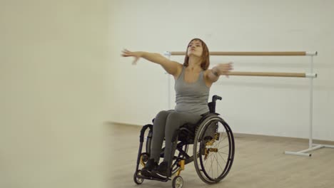 paraplegic woman in wheelchair learning dancing moves