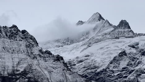 Grindelwald-mountain-glacier-glacial-peaks-stunning-Switzerland-Swiss-Alps-snowy-Jungfrau-Junfrangu-Lauterbrunnen-October-cloudy-autumn-evening-landscape-top-of-gondola-ride-view-zoomed-static-shot