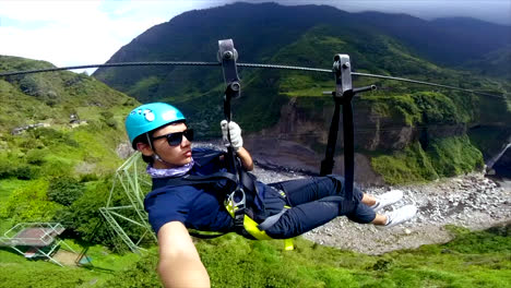 Foto-De-Cámara-De-Acción-Selfie-De-Un-Joven-Montando-Tirolesa-En-Baños,-Ecuador