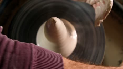 male potter making pot