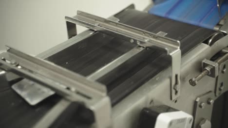 automated production line processing medical blister packs in pharmaceutical factory.