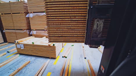 wooden production. forklift carries a wooden boards through the warehouse. bunch of wooden panels moving on a truck inside the workshop.
