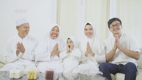 muslim family showing a greeting hands at home