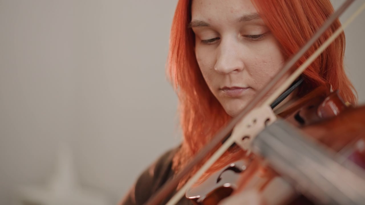 Closeup hands adjusting violin bow grip and wrist movement, tutor demonstrates correct hold and finger placement focused technique session with calm studio lighting and detailed posture correction
