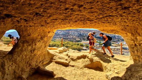 tourists exploring the historical venetian fortezza castle, citadel in rethimno, greece. - wide shot