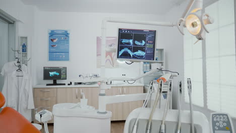 interior of empty stomatology orthodontist office room equipped with x ray on monitors