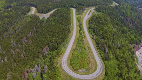 aerial drone shot panning downwards showing the famous bay of fundy trail parkway located off the bay of fundy in new brunswick, canada shot during a hot summers day