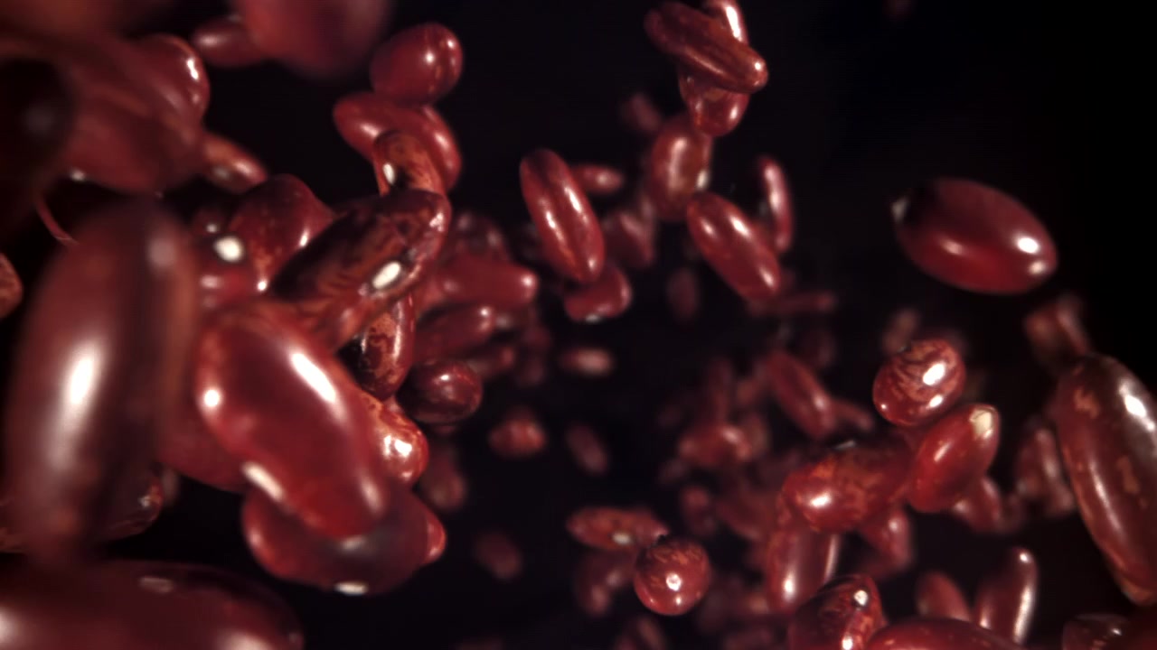 Red Kidney Beans Floating in Slow Motion on a Dark Background
