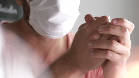 Man-with-beard-wearing-protective-face-mask-and-shaking-his-head,-close-up-interior-shot