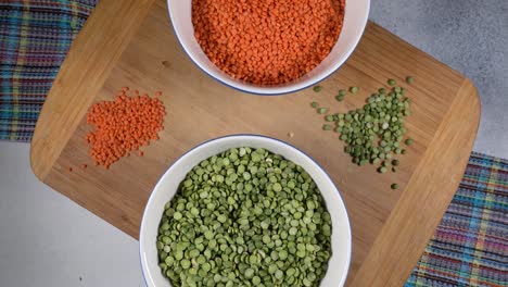 red lentils and green peas. high protein legumes,beans and lentils for vegetarians.circular rotation on the table.