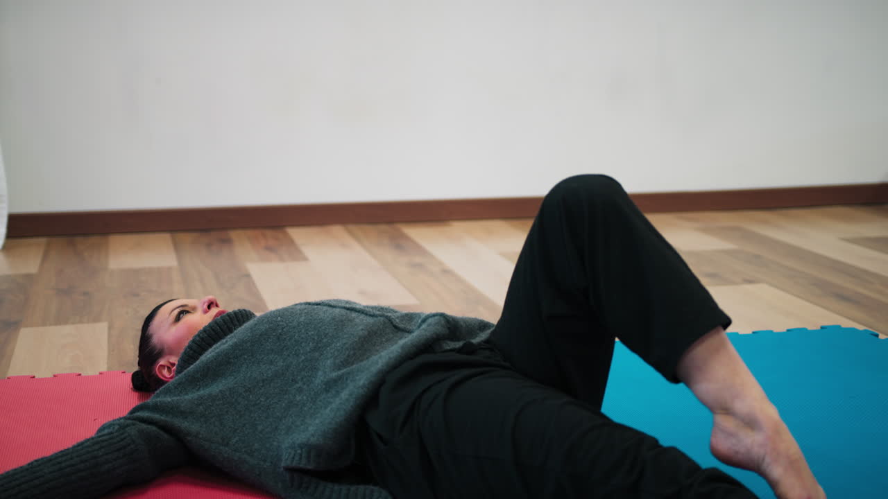 Italian Woman Trains Muscles For Slow Dance And Stretching On Tatami In Gym