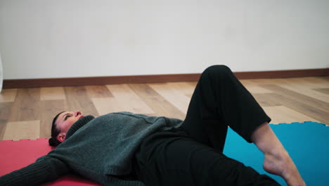 italian woman trains muscles for slow dance and stretching on tatami in gym