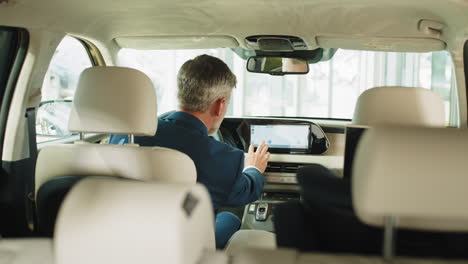 businessman using navigation system in a modern car