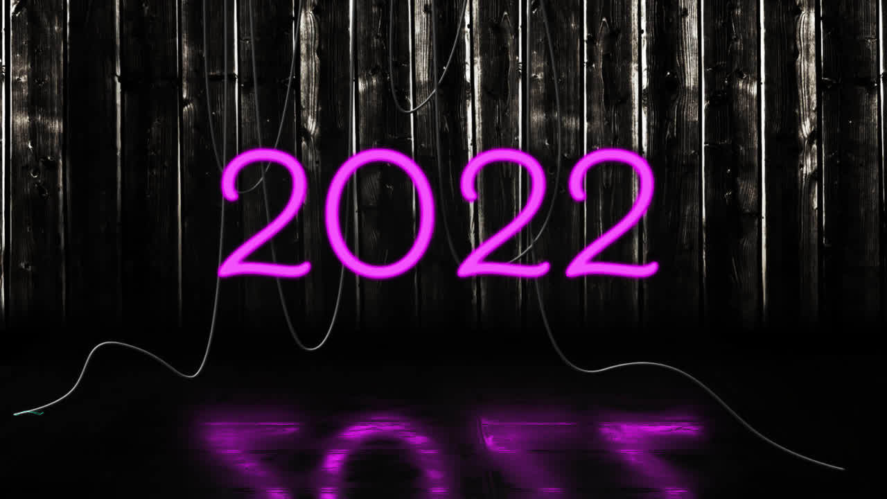 animación del texto de 2022 en neón rosa, con cables colgantes en fondo negro