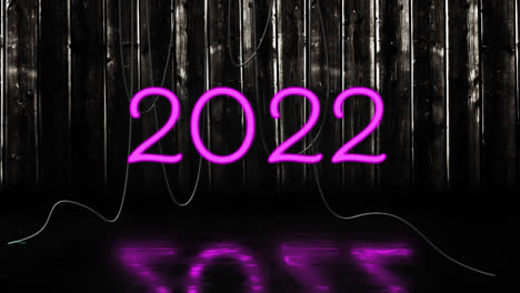 Animación-Del-Texto-2022-En-Neón-Rosa,-Con-Cables-Colgantes-Sobre-Fondo-Negro