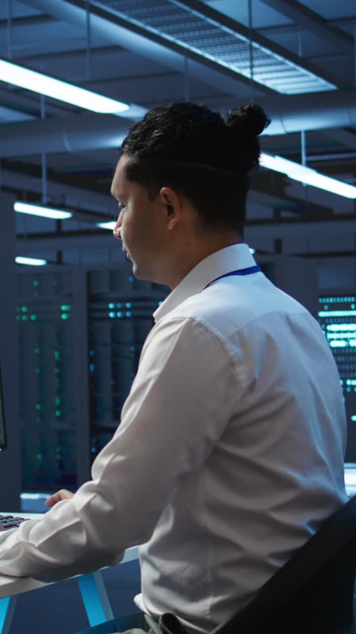 IT Professional Working with Code on Tablet and Computer in Data Center
