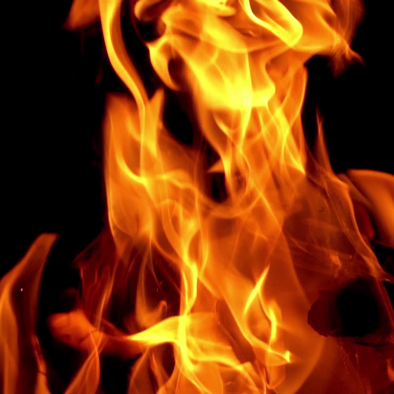 Camp fire in the night. Hot coals in the fire. Slow motion