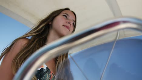 Close-up-of-young-woman-driving-a-motorboat