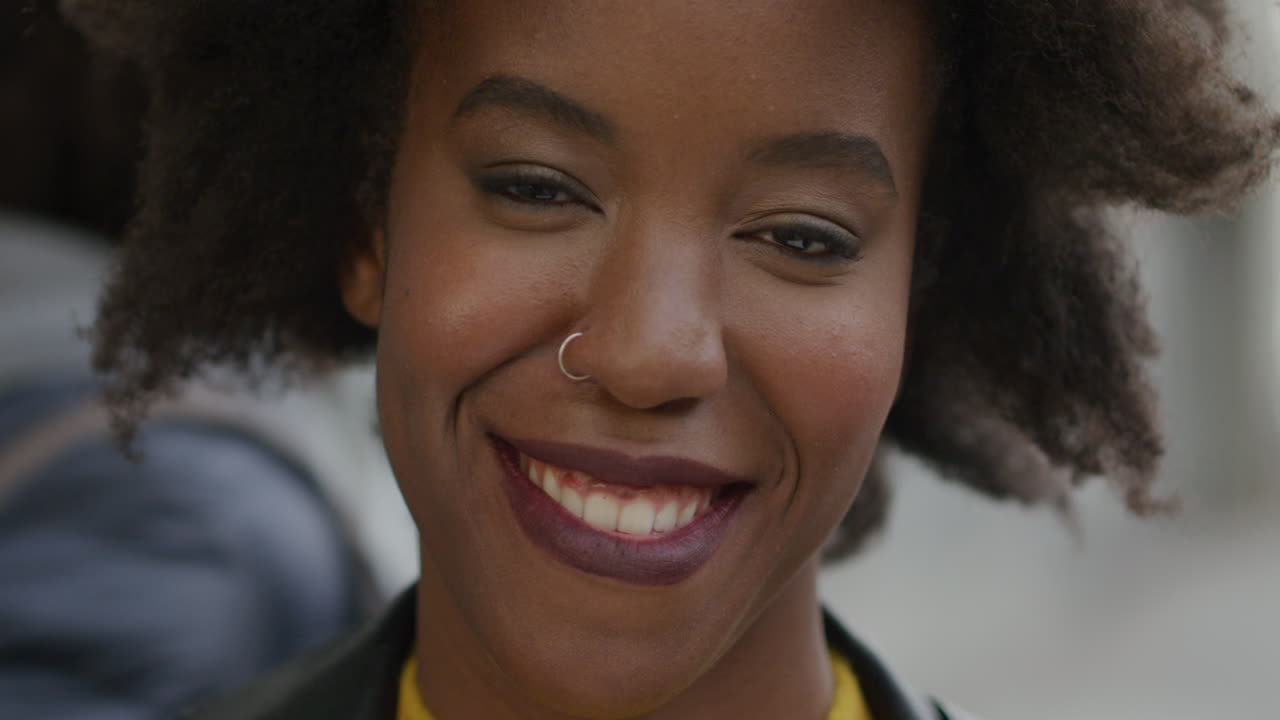 Portrait happy african american woman smiling in city