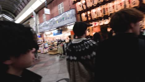 people walking through a bustling shopping arcade