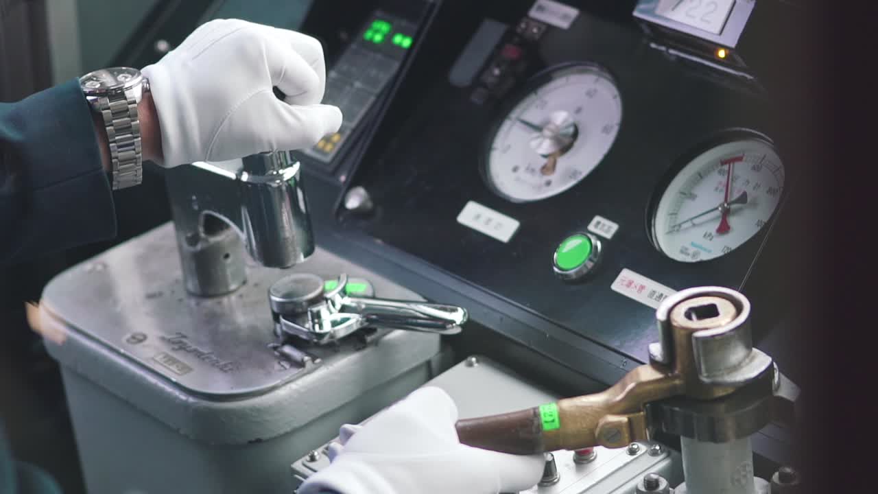 Hands Of A Japanese Train Conductor Driver Driving The Train In Kyoto, Japan. Inside The Cabin Of Train.. - close up shot